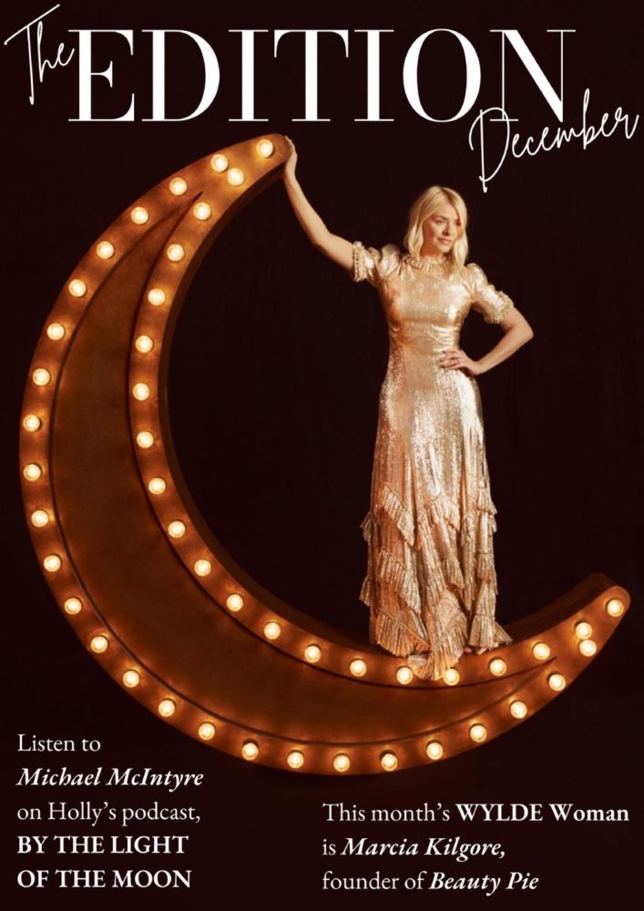 Holly Willoughby standing on a light-up crescent moon wearing a gold dress