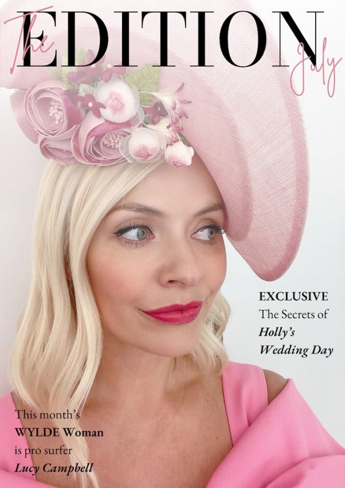 Holly Willoughby wearing a pink fascinator hat with bold lipstick for the cover of Wylde Moon magazine July 2022