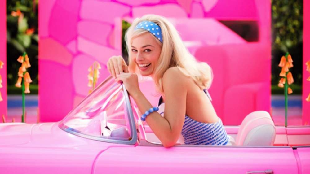 Margot Robbie driving a pink car for the new Barbie movie