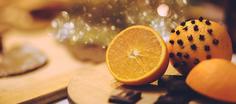 Oranges with cloves and christmas lights
